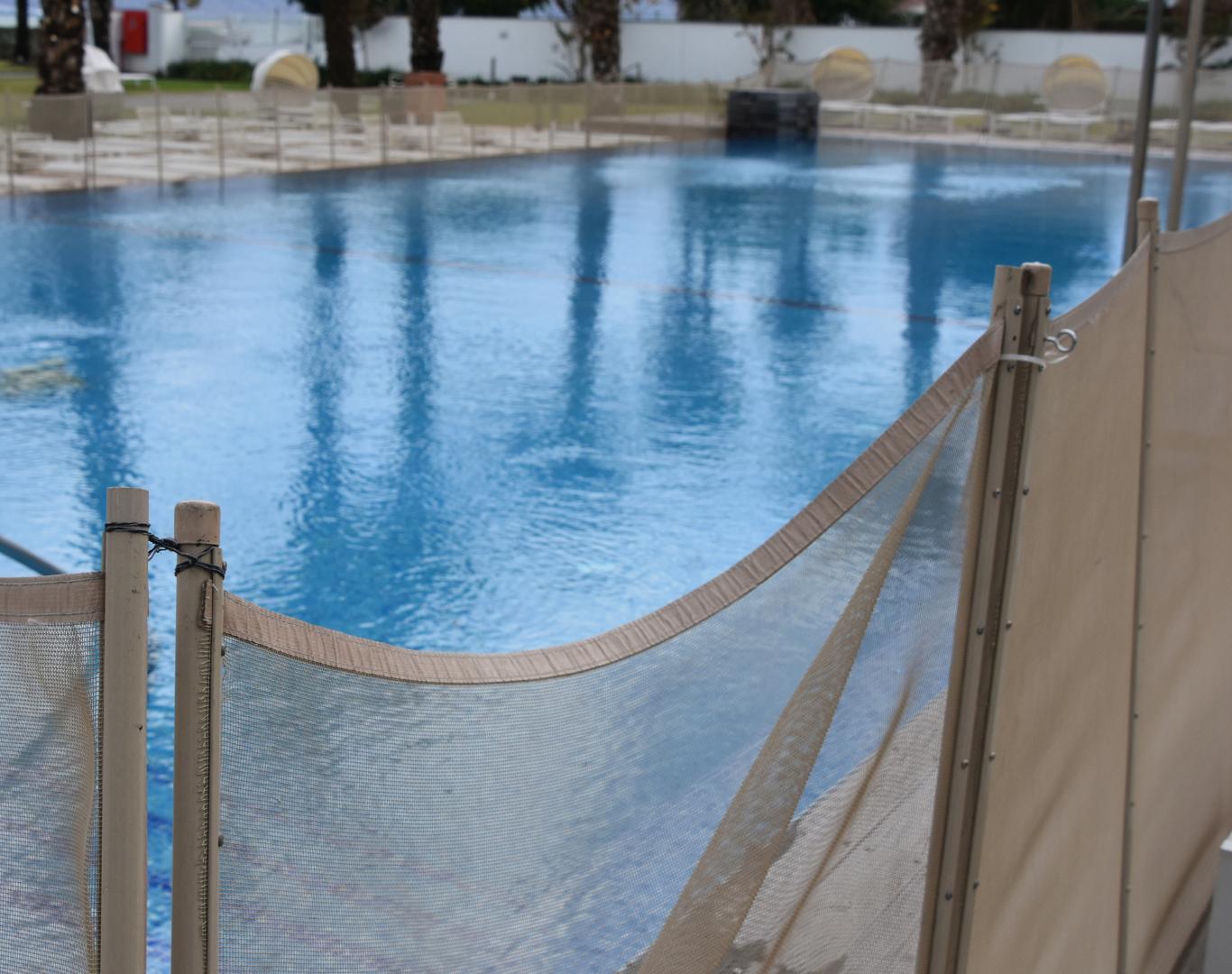 Professional technician performing routine Pool Service in Broadview Heights, OH for residential backyard swimming pool maintenance